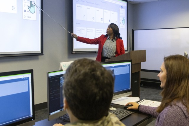 Talonda Mott, U.S. Army Financial Management Command System Support Operations financial systems instructor, explains various portions of SAP BI Business Objects 4.3 to Sgt. 1st Class Julie Kraemer and Melanie Smith, 84th Training Command budget analysts, at the Maj. Gen. Emmett J. Bean Federal Center in Indianapolis Dec. 12, 2022. USAFMCOM now offers an in-residence, 3-day class on SAP BI Business Objects 4.3 to help financial and resource managers leverage a modernized system to provide critical financial data to commanders while dramatically cutting their time to build financial reports. (U.S. Army photo by Mark R. W. Orders-Woempner)