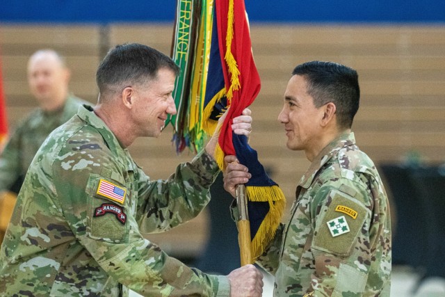 Maj. Gen. David Hodne, commanding general of the 4th Infantry Division and Fort Carson, receives the 4th Inf. Div. colors from Command Sgt. Maj. Alex Kupratty, incoming senior enlisted advisor of the 4th Inf Div. and Fort Carson during a change of responsibility ceremony hosted by the 4th Infantry Division, Jan. 6 at Fort Carson, Colorado. The passing of the colors is a tradition that marks a change in leadership. 