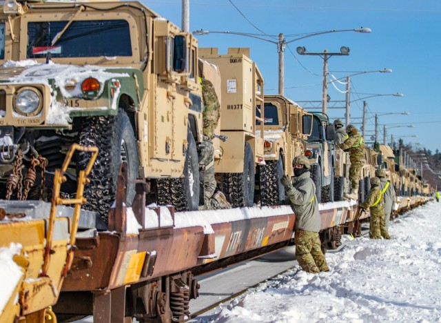 Soldiers from 10th Mountain Division take the final steps to make sure the vehicles on the railhead are ready for transport to Fort Polk, Louisiana.