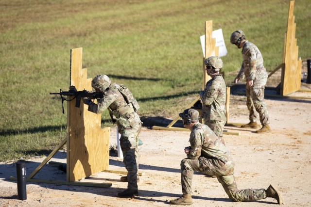 A member of Squad 5, representing the U.S Army Special Operations Command, fires his M-4 carbine rifle during the stress shoot portion of the Army Best Squad Competition on Fort Bragg, North Carolina, Oct. 5, 2022. Each squad competing in the Army Best Squad Competition consists of five Soldiers; a squad leader, which is a sergeant first class or staff sergeant; a team leader, which is a sergeant or corporal; and three squad members in the ranks of specialist or below.