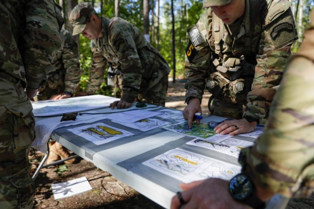 Soldiers of Squad 5, representing the U.S. Army Special Operations Command, train on land navigation during the Army’s first-ever Best Squad Competition on Fort Bragg, North Carolina, Oct 2, 2022. The Army Best Squad Competition tests Soldiers on their individual and collective ability to adapt-to and overcome challenging scenarios and battle-readiness events, evaluating their physical and mental endurance, technical and tactical abilities, and basic warrior skills under stress and extreme fatigue.