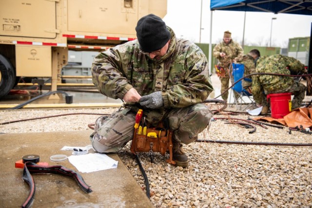 Sgt. Evan Histed, a student attending the Production Specialist Course, removes insulation from a medium-voltage cable during a capstone event in December at the U.S. Army Prime Power School. 