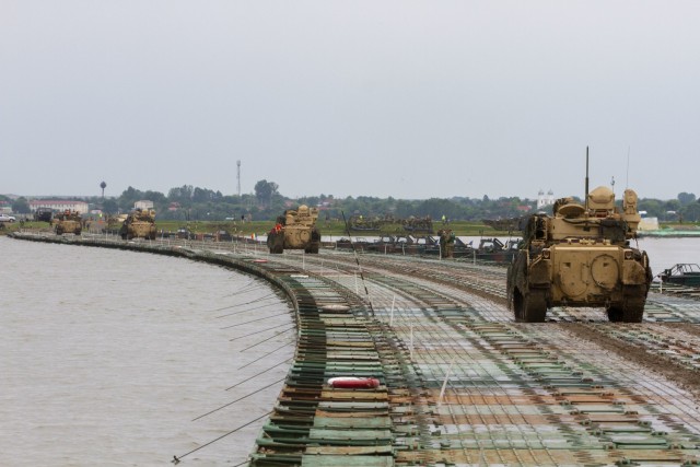 M3 Bradley Fighting Vehicles assigned to 1st Battalion, 16th Infantry Regiment, 1st Armored Brigade Combat Team, 1st Infantry Division cross the Danube river during the culminating exercise of Saber Guardian 19 at Bordusani Romania, June 20, 2019....