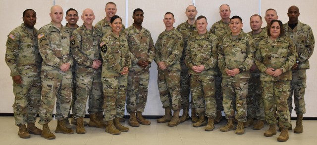 Command Sgt. Maj. Linwood Barrett, left-center, U.S. Army Signal School command sergeant major, poses for a photo during a reception following his assumption of responsibility ceremony Jan. 10 at Fort Gordon.