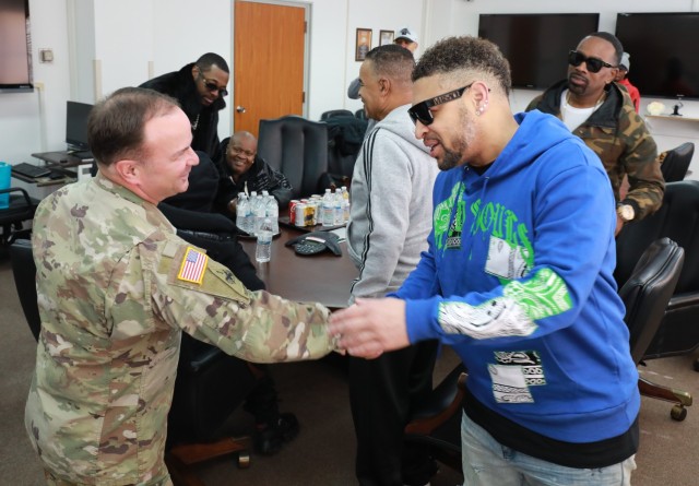 U.S. Army Garrison Japan Commander Col. Christopher L. Tomlinson, left, shakes hands with Dru Hill member Smoke Jan. 10, 2023, at the USAG Japan headquarters. The group toured the installation and met with Soldiers prior to their concert that night at the Camp Zama Community Club. 