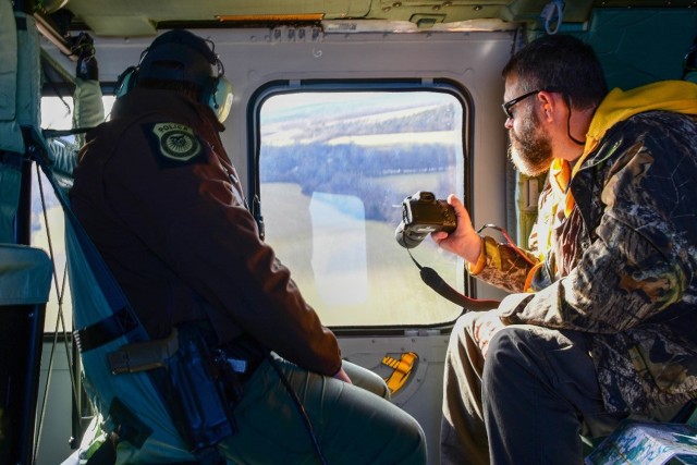 Conservation Law Enforcement Officer Eric Magoon (left) and Natural Resources Branch Chief Kenton Lohraff, search for and document bald and golden eagles, as well as other waterfowl, from the air Jan. 4, during the 2023 Midwinter Bald Eagle Survey of Pulaski County. 