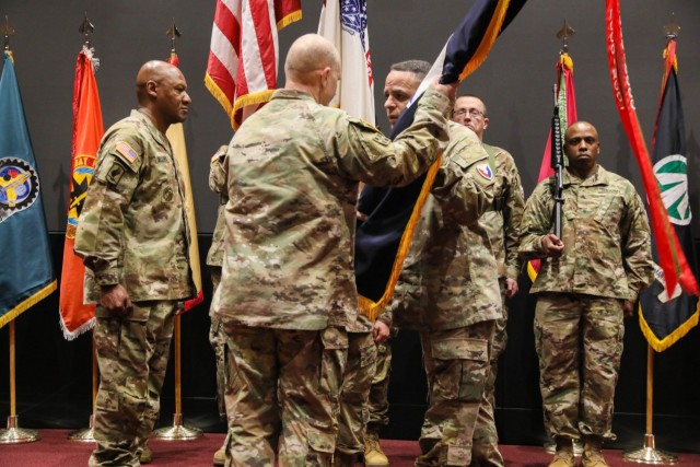 Army Materiel Command’s outgoing Command Sgt. Maj. Alberto Delgado shares a moment with AMC commander Gen. Ed Daly during the traditional the transferring of colors at a change of responsibility ceremony at Redstone Arsenal Jan. 12. To the left...