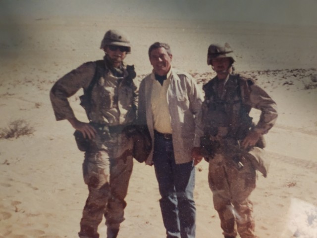 Then-Staff Sgt. Jim Gill, right, poses for a photo with CBS News reporter Dan Rather and another Soldier during the Gulf War. Gill, a veteran of both Operation Desert Storm and Desert Shield, recently reflected on his experiences in honor of Desert Storm&#39;s 32nd anniversary. 