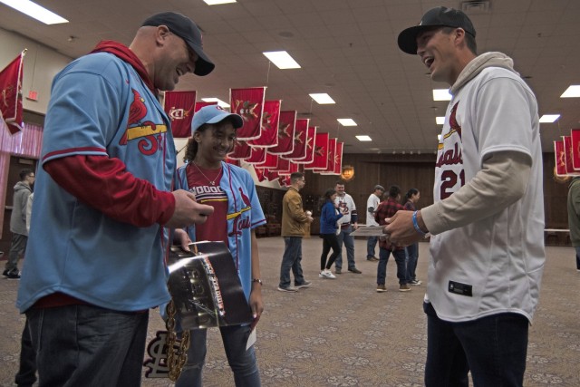 St. Louis Cardinals outfielder Lars Nootbar meets Sgt. 1st Class Ryan Wells, with the Maneuver Support Center of Excellence NCO Academy, and his daughter Layla, on Saturday during a Cardinals Caravan event in the Engineer Regimental Room at Fort...