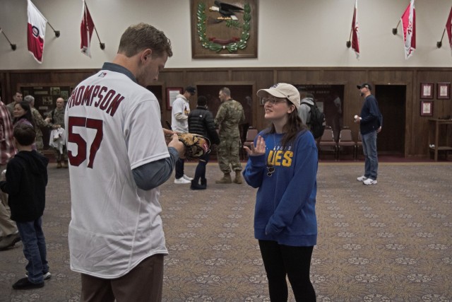 Nicole Nemetz, a sports assistant with the Directorate of Family and Morale, Welfare and Recreation, gets her baseball glove signed by Cardinals pitcher Zack Thompson on Saturday during a Cardinals Caravan event in the Engineer Regimental Room at...