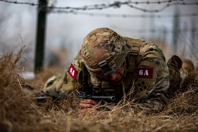 Spc. Brandon Gracia, Combat Medic Specialist, 4th Infantry Division, perform the low crawl during an physical training exercise for the Army&#39;s Best Medic Competition. Twenty-two two-Soldier teams from all around the world traveled to Fort...