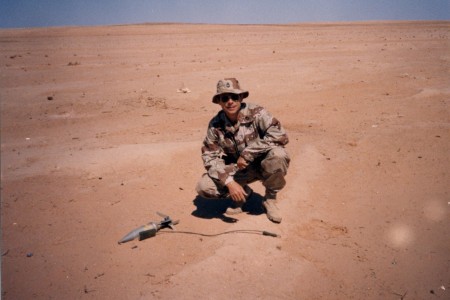 Sgt. Maj. Mike R. Vining places a charge on a dud AT-4 rocket in Saudi Arabia in March 1991.  Vining served in Operation Desert Storm.  