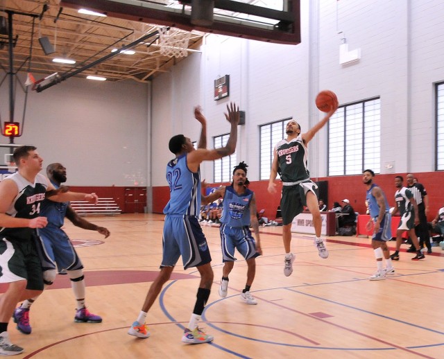 Titus Gary of the Charleston, South Carolina Military Base Team slides his way to the hoop during his team’s 82-73 loss against the Joint Base Langley-Eustis Raptors during the Martin Luther King Basketball Classic title game Jan. 16 at MacLaughlin Fitness Center. 