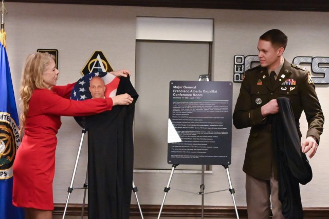Margaret Espaillat Beaulac, Maj. Gen. Francisco Espaillat&#39;s former spouse, and her son, Capt. (Promotable) Richard Espaillat, unveil the placards which are now placed on the exterior of the PEO Combat Support & Combat Service Support Espaillat Conference Room.