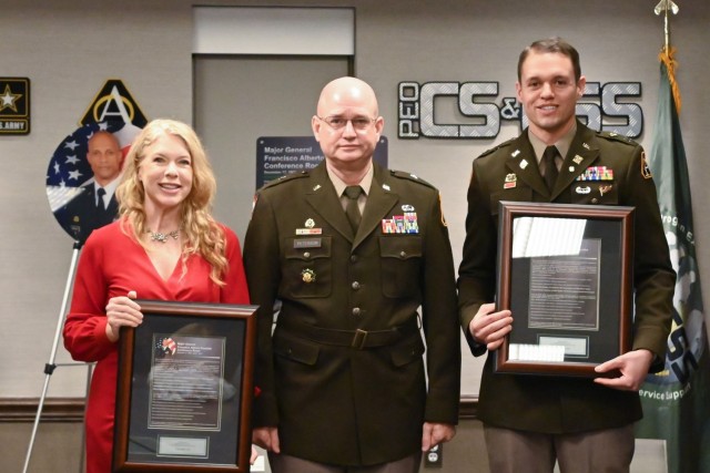 PEO Combat Support & Combat Service Support Brig. Gen. Samuel L. Peterson (center) presented mementos to Margaret Espaillat Beaulac and Capt. (Promotable) Richard Espaillat by which to remember the conference room dedication.