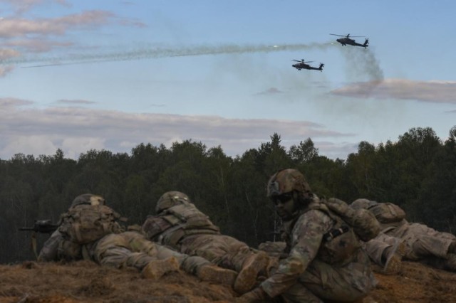 U.S. Army AH-64 Apache helicopters with 12th Combat Aviation Brigade provide fire support for U.S. Army paratroopers assigned to 173rd Airborne Brigade during a combined arms live fire exercise on a maneuver range at the Grafenwoehr Training Area, Germany, Sept. 22, 2022. The 173rd Airborne Brigade is the U.S. Army&#39;s Contingency Response Force in Europe, providing rapidly deployable forces to the United States European, African, and Central Command areas of responsibility. Forward deployed across Italy and Germany, the brigade routinely trains alongside NATO allies and partners to build partnerships and strengthen the alliance. (U.S. Army photo by Markus Rauchenberger)