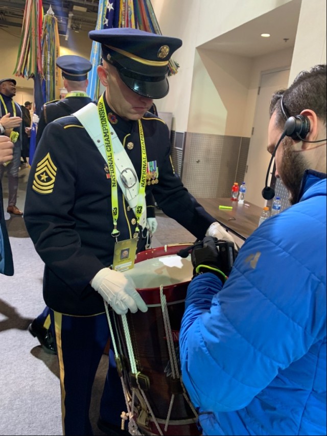 Sgt. Major Brian Spurgeon,  from the U.S. Army Field Band, gets a wireless microphone attached to his drum prior to colors presentation just before the 2023 College Football Playoff National Championship Game on January 9, 2023 at SoFi Stadium in Los Angeles.