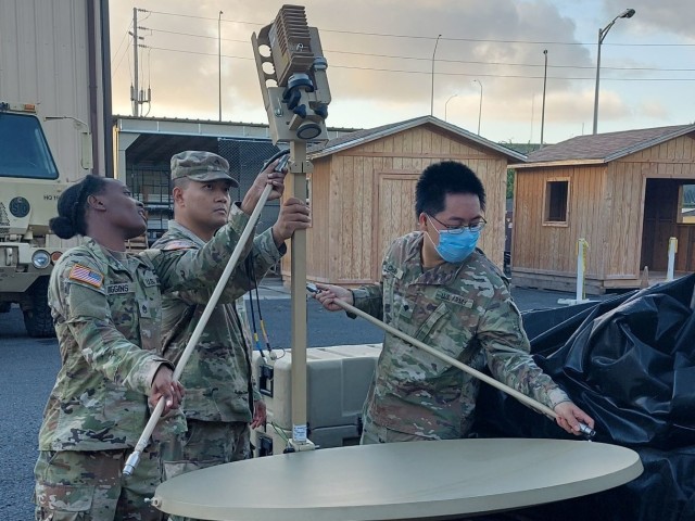 Staff Sgt. Yvonne Wiggins, Cpl. Mark Dayag and Spc. David Chan, 303rd Maneuver Enhancement Brigade, assemble the upgraded Very Small Aperture Terminal (VSAT) Satellite system as part of a familiarization class at Fort Shafter, HI on Dec. 22nd 2022.