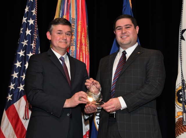 The Honorable Douglas R. Bush (left), Assistant Secretary of the Army (Acquisition, Logistics, and Technology) and Army Acquisition Executive, presented George Matook (right), Program Manager of the Measuring and Advancing Soldier Tactical Readiness and Effectiveness, or MASTR-E, Program at the U.S. Army Combat Capabilities Development Command Soldier Center, with the Science and Technology Professional of the Year Award for the 2022 Army Acquisition Executive&#39;s Excellence in Leadership Awards during a ceremony held at the Pentagon auditorium on January 10, 2023.