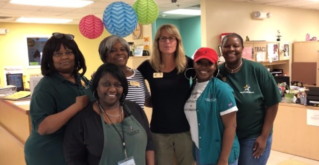 Sunny Bolton, Fort Jackson Child, Youth Services coordinator, poses with CYS teammates during a video.