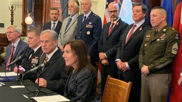 Asst. Sec. of the Army  (IE&E) Rachel Jacobson remarks on the newly signed intergovernmental support agreement (IGSA) between Texas and the military services Jan. 25, 2023, joined by Texas Gov. Greg Abbott (left), Sgt. Maj. Michael J. Perry (rear) of DCS, G-9,  and other leaders. (David Leinberger, US Army)