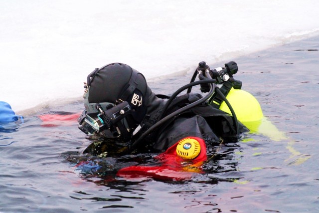 Fort McCoy firefighters hold ice rescue diving training at frozen-over installation lake