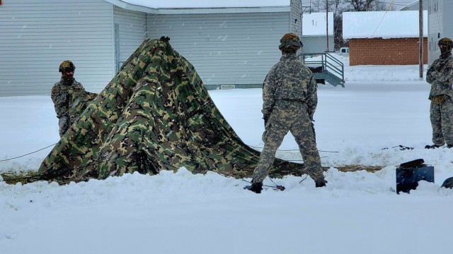 Airmen learn to build Arctic 10-person tents during cold-weather training at Fort McCoy