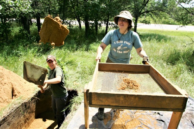 Archaeologists Cassie Mohney and Megan Kasten work in an area of the Fort McCoy (Wis.) cantonment area July 23, 2014. They are part of a team of archaeologists under contract with Fort McCoy that searches several areas of the post for artifacts as...