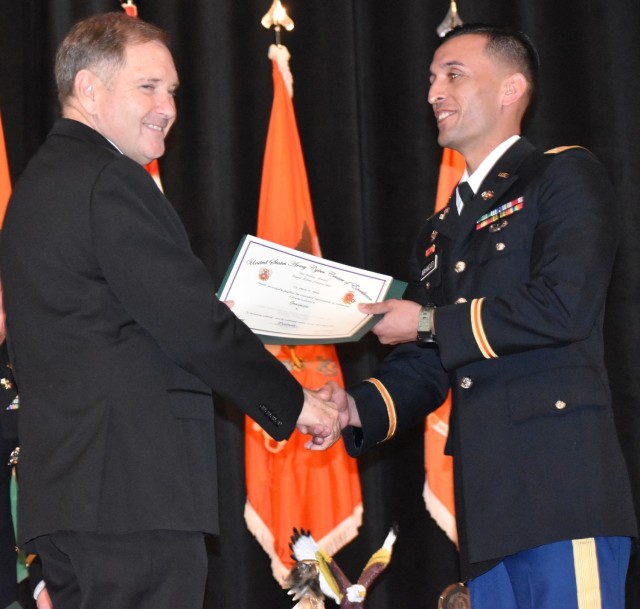 Second Lt. Ahmad Rashid Mahmoodi accepts his diploma during a graduation ceremony recognizing Signal Basic Officer Leaders Course, Class 008-22, at Fort Gordon, Georgia, on Jan. 20.