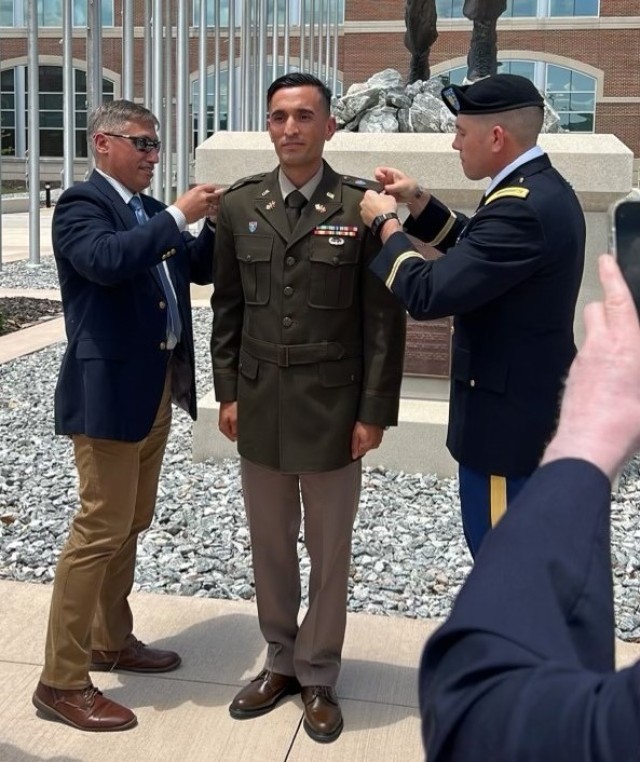 Maj. Daniel Harrison, right, participates in a pinning ceremony for 2nd Lt. Ahmad Rashid Mahmoodi.