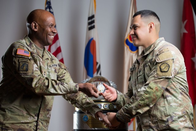 Maj. Gen. Joseph D’costa, Eighth Army deputy commanding general for sustainment, presents coins to coins from the Office of the Secretary of Defense to the 551st ICTC.