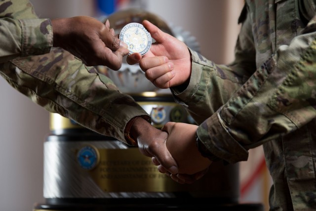 Maj. Gen. Joseph D’costa, Eighth Army deputy commanding general for sustainment, presents coins to coins from the Office of the Secretary of Defense to the 551st ICTC.