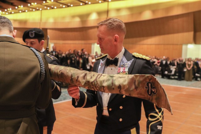 U.S. Army Col. Kevin R. Sharp inspects the casing of the brigade colors Feb. 3, 2023, to signify upcoming deployment to the U.S. Army European Command area of operations.