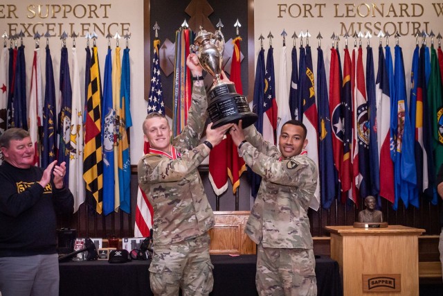 Retired Lt. Gen. Robert Flowers, namesake of the competition (left), applauds as 1st Lt. Eric Mattia and Capt. Alaimoana Paunga, Team 17 with 20th Engineer Battalion out of Fort Hood, Texas, lift the trophy in celebration of winning the 15th Best...