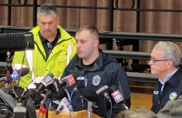 Master Sgt. David Hurst of the Ohio National Guard’s 52nd Civil Support Team discusses the potential impact of a chemical plume from a train derailment in East Palestine, Ohio, as Gov. Mike DeWine, right, looks on during a press conference Feb....