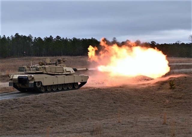 Pvt. 1st Class Kristie Hawley fires the 120mm cannon of an M1A2 Abrams Main Battle Tank