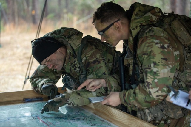 Sgt. Thomas Mulhern, left and Sgt. Klayton McCallum, both members of the New York Army National Guard&#39;s 2nd Battalion, 108th Infantry, check out a map before starting  an event at the Army Best Medic Competition on January, 24, 2023 at Fort Polk Louisiana. The Two New York Army Guard Soldiers represented the Army National Guard during the competition. ( U.S. Army Photo by Sgt. Terry Vongsouthi)