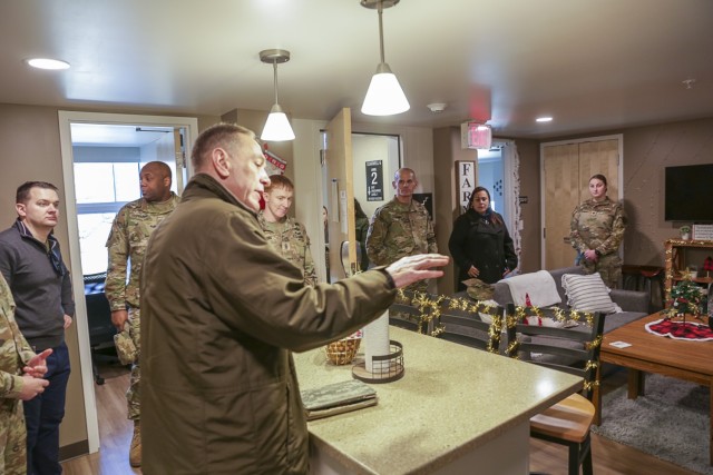 LTG Omar Jones, Commanding General, IMCOM, center, is briefed by Brian Smith, with Fort Belvoir Garrison Housing Manager about the renovated enlisted barracks, during a Congressional staff delegation housing tour, Dec. 9.