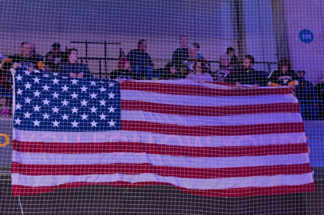 Team Tobyhanna employees and famil members unfurl flag for Star-Spangled Banner