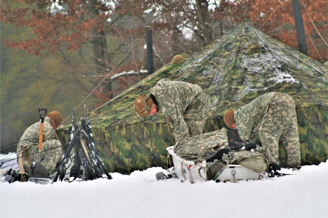 Airmen learn to build Arctic 10-person tents during cold-weather training at Fort McCoy