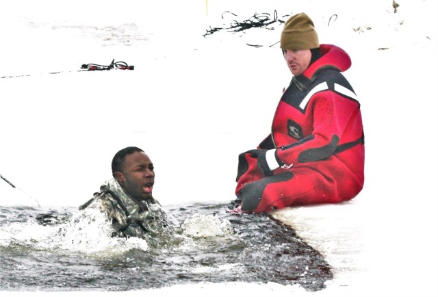 Airmen jump in icy Fort McCoy lake for January cold-water immersion training
