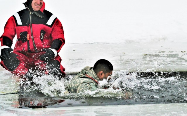 Airmen jump in icy Fort McCoy lake for January cold-water immersion training