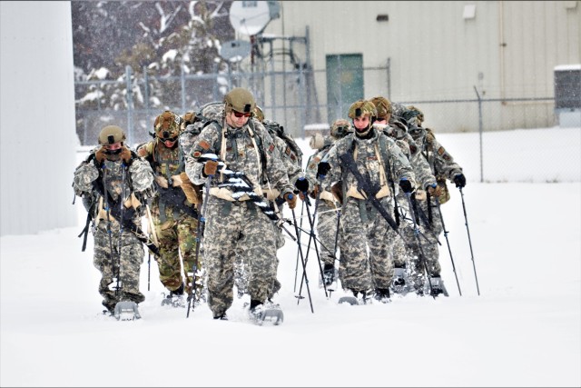 Airmen with multiple Air National Guard security forces units learn squad tactics pulling an ahkio sled Jan. 19, 2023, as part of a 16-day Cold-Weather Operations Course led by the Air Force at Fort McCoy, Wis. More than 50 Airmen are participating in the training from across the Air Force. Besides learning about use of snowshoes and moving as a squad over terrain pulling an ahkio sled in a cold-weather environment, the Airmen also learned about cold-weather shelters, survival techniques, cold-weather uniform wear, and more. Fort McCoy has a long history of supporting cold-weather training. Eighty years prior to this training, in January 1943, the installation hosted winter training for the Army's 76th Division prior to the Division deploying to Europe to fight in the Battle of the Bulge in World War II. (U.S. Army Photo by Scott T. Sturkol, Fort McCoy Public Affairs Office)