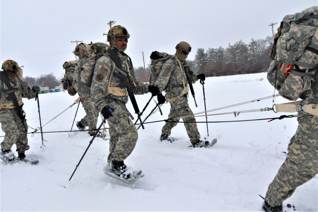 Airmen with multiple Air National Guard security forces units learn squad tactics pulling an ahkio sled Jan. 19, 2023, as part of a 16-day Cold-Weather Operations Course led by the Air Force at Fort McCoy, Wis. More than 50 Airmen were participating in the training from across the Air Force. Besides learning about use of snowshoes and moving as a squad over terrain pulling an ahkio sled in a cold-weather environment, the Airmen also learned about cold-weather shelters, survival techniques, cold-weather uniform wear, and more. Fort McCoy has a long history of supporting cold-weather training. Eighty years prior to this training, in January 1943, the installation hosted winter training for the Army's 76th Division prior to the Division deploying to Europe to fight in the Battle of the Bulge in World War II. (U.S. Army Photo by Scott T. Sturkol, Fort McCoy Public Affairs Office)