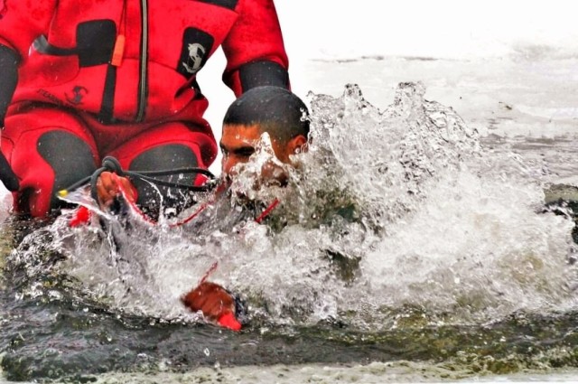 Airmen jump in icy Fort McCoy lake for January cold-water immersion training