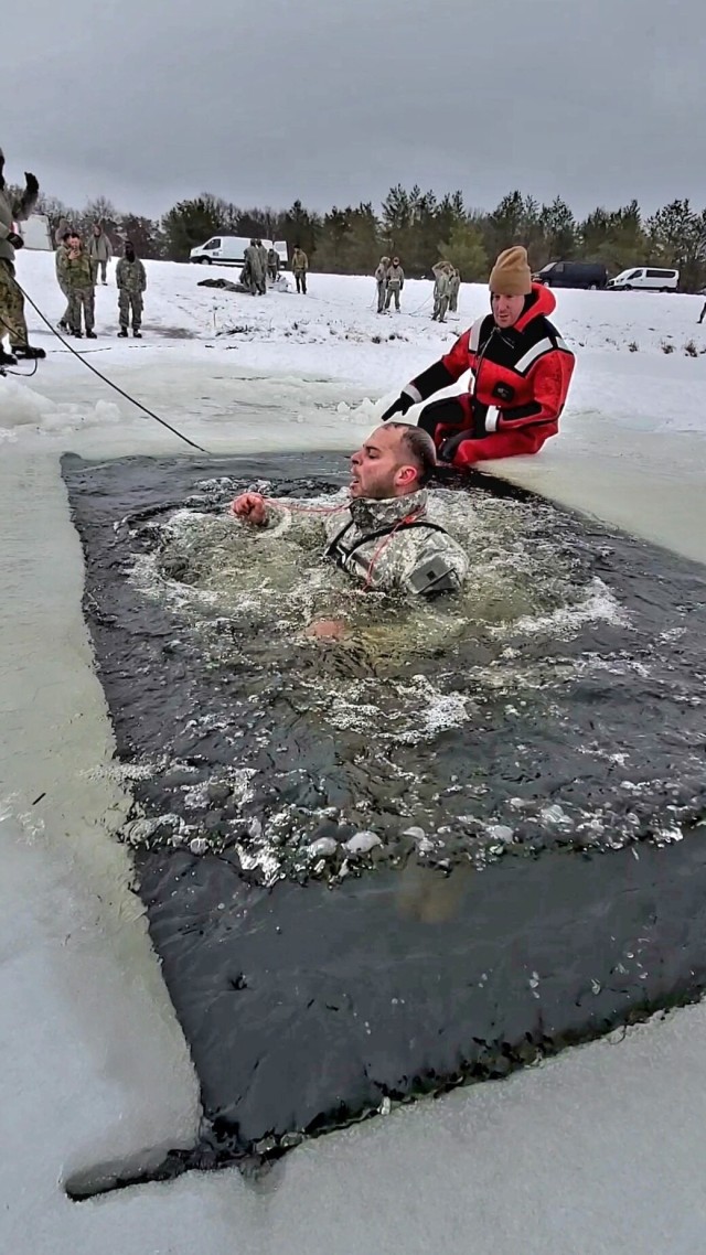 Airmen jump in icy Fort McCoy lake for January cold-water immersion training