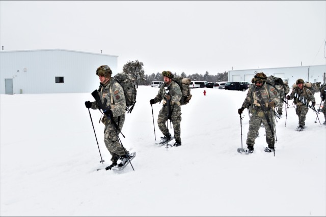 Airmen with multiple Air National Guard security forces units learn squad tactics pulling an ahkio sled Jan. 19, 2023, as part of a 16-day Cold-Weather Operations Course led by the Air Force at Fort McCoy, Wis. More than 50 Airmen are participating in the training from across the Air Force. Besides learning about use of snowshoes and moving as a squad over terrain pulling an ahkio sled in a cold-weather environment, the Airmen also learned about cold-weather shelters, survival techniques, cold-weather uniform wear, and more. Fort McCoy has a long history of supporting cold-weather training. Eighty years prior to this training, in January 1943, the installation hosted winter training for the Army's 76th Division prior to the Division deploying to Europe to fight in the Battle of the Bulge in World War II. (U.S. Army Photo by Scott T. Sturkol, Fort McCoy Public Affairs Office)