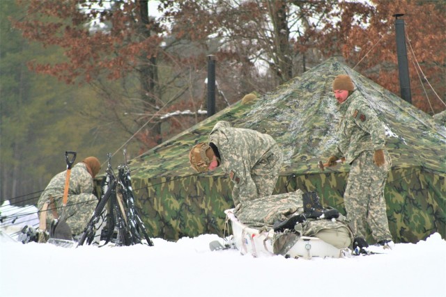 Airmen learn to build Arctic 10-person tents during cold-weather training at Fort McCoy