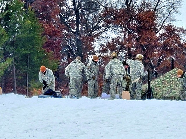 Airmen learn to build Arctic 10-person tents during cold-weather training at Fort McCoy