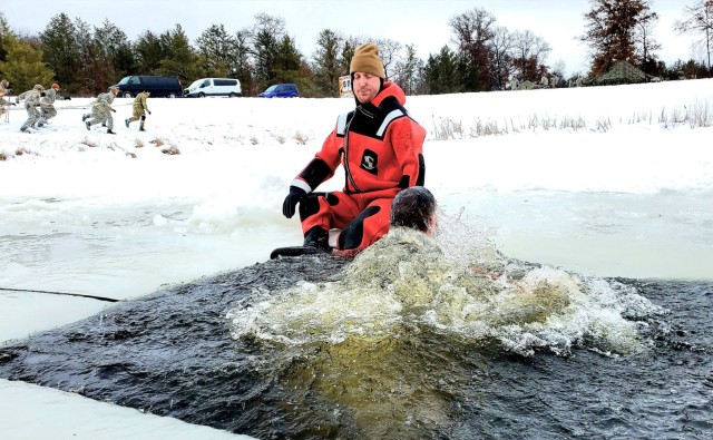 Airmen jump in for cold-water immersion training as part of Air Force-led Cold-Weather Operations Course at Fort McCoy